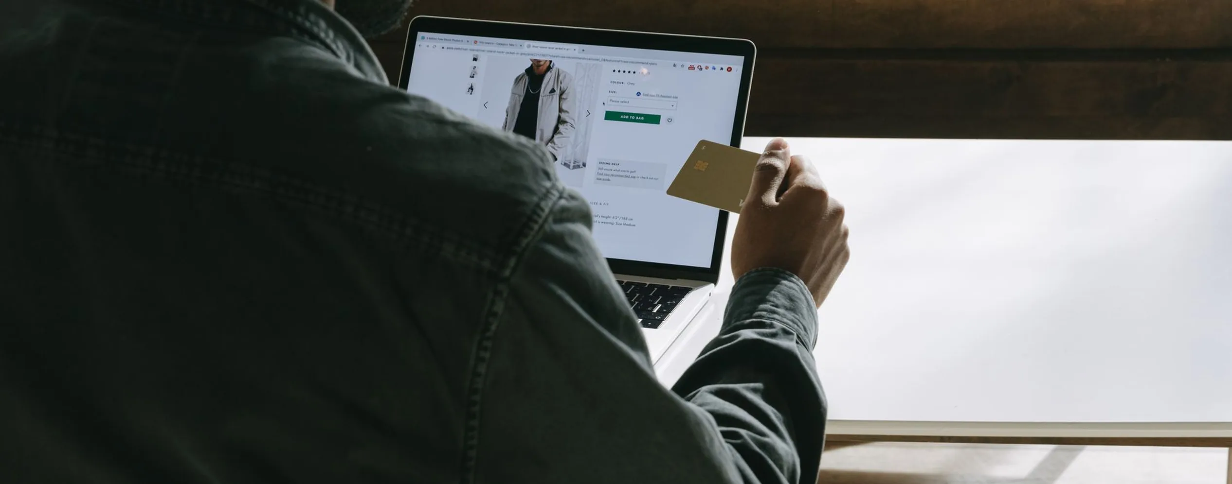 Shopper paying by card on a laptop store